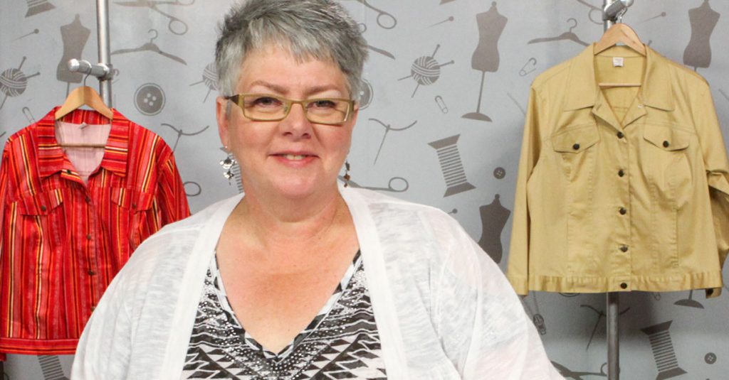 Older woman with short grey hair looking at the camera