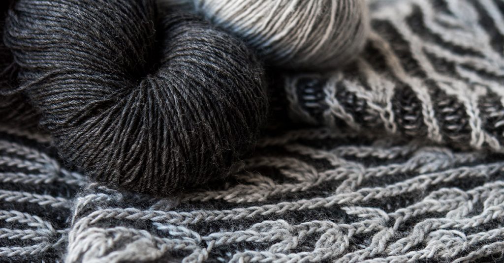 Close up of light and dark grey yarn