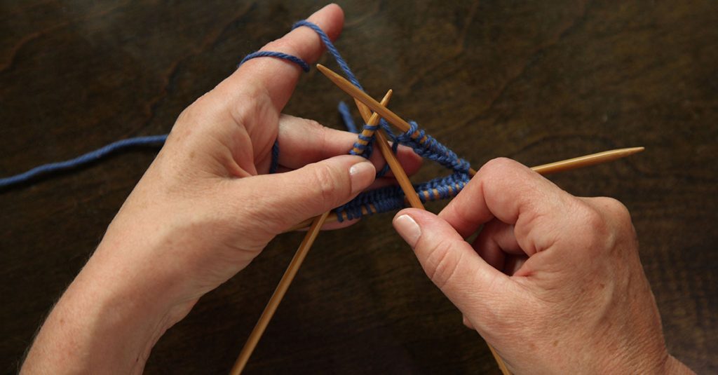 Knitting with blue yarn