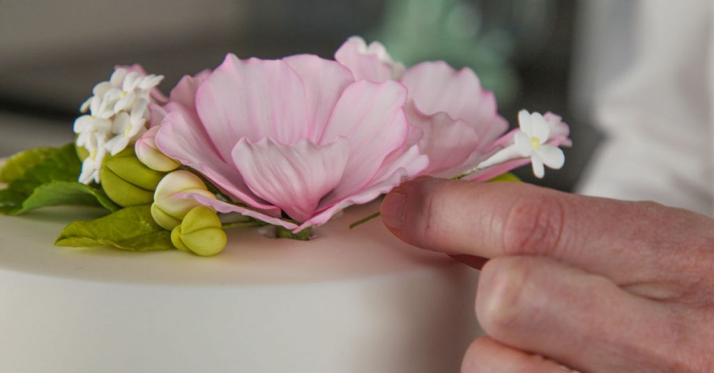 Putting flowers into a cake top