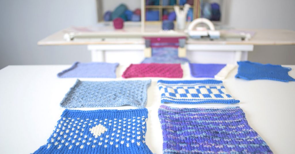 Blue, pink, purple and white knit squares around a table