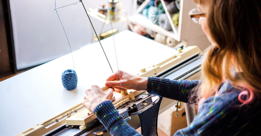 Woman machine knitting