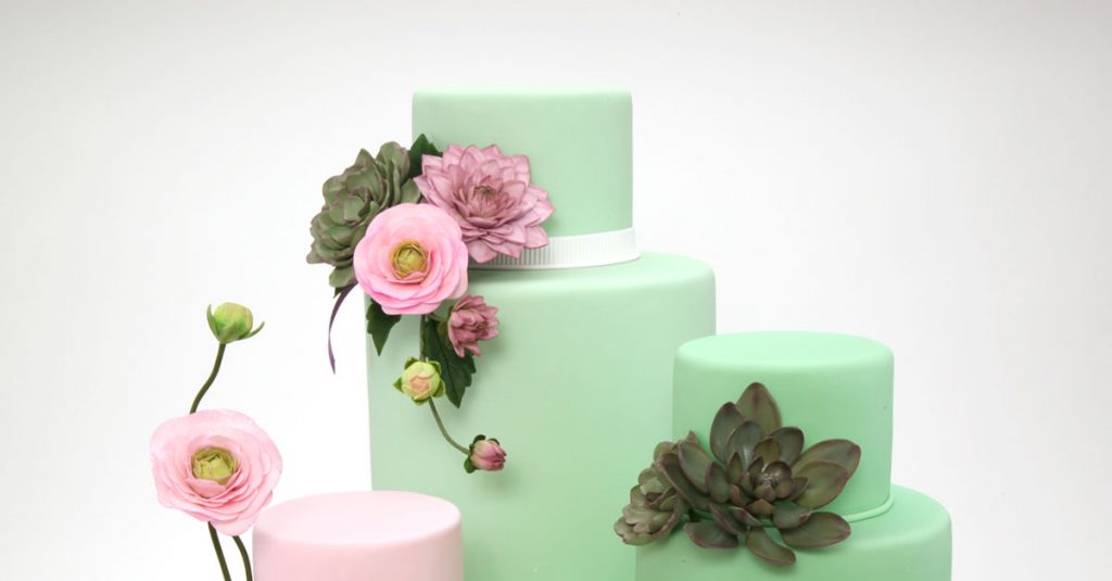 Cakes decorated with flowers and greenery