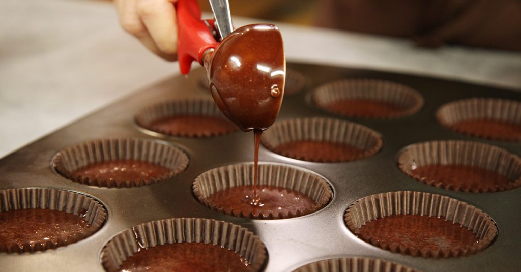 Pouring batter into muffin tins