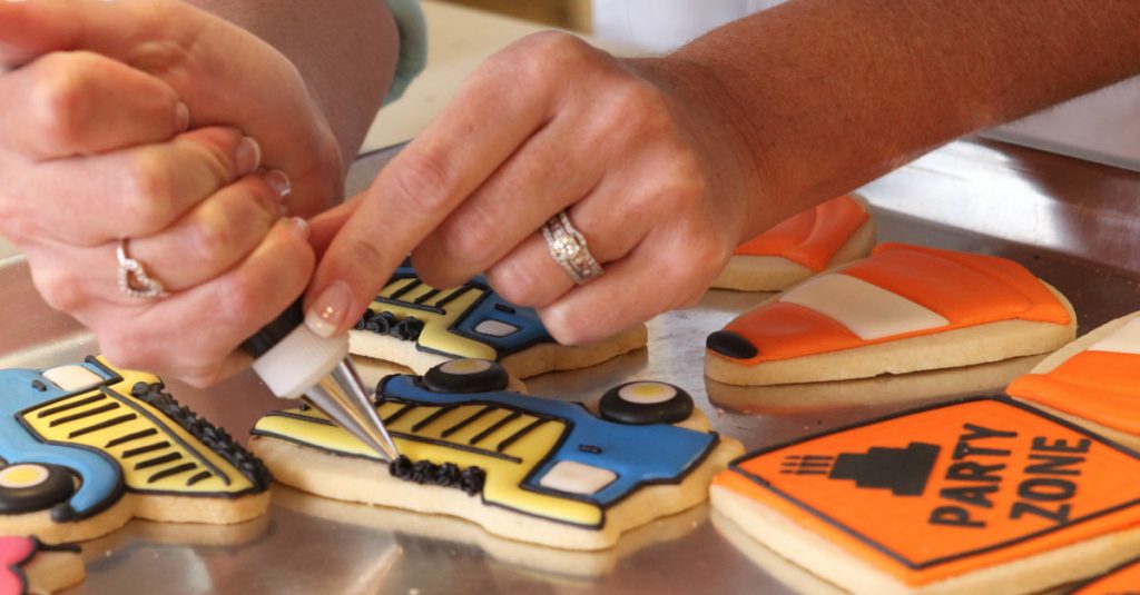 Decorating sugar cookies with construction theme