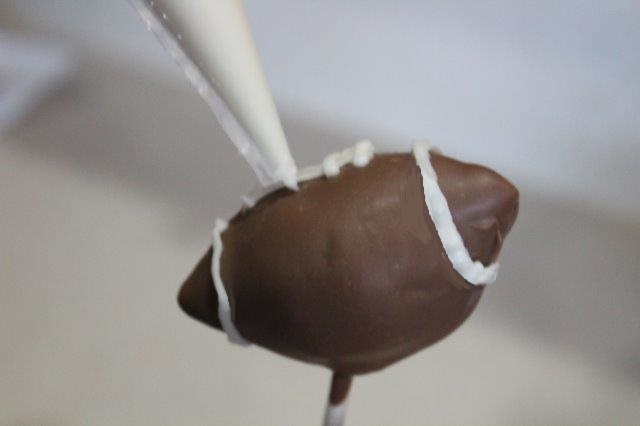 Piping the Laces onto Game Day Cake Pops