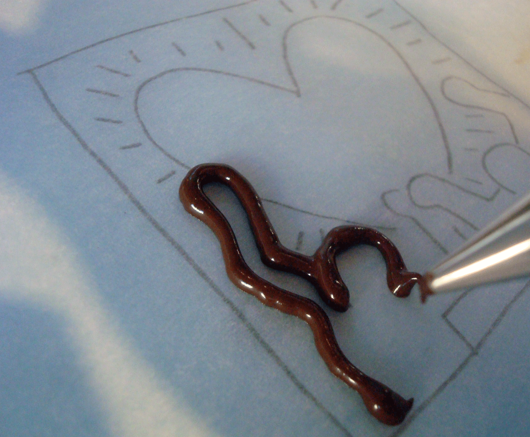 Piping Chocolate onto Design