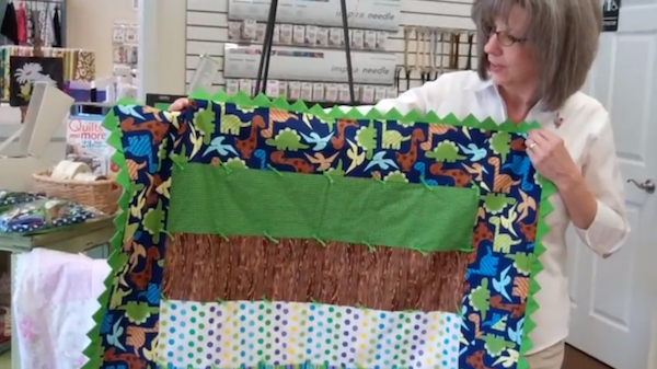 Woman Holding Quilt with Prairie Points