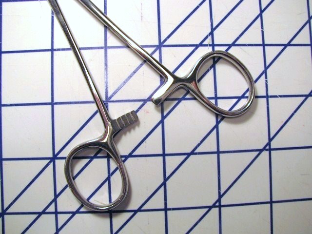 Hemostat on Lined Paper