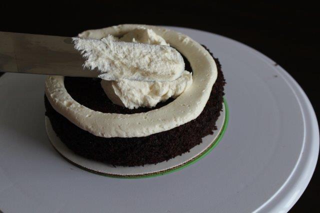 First Tier of a Chocolate Cake Getting Filled with Buttercream