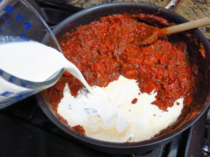 Adding the cream to chicken tikka masala