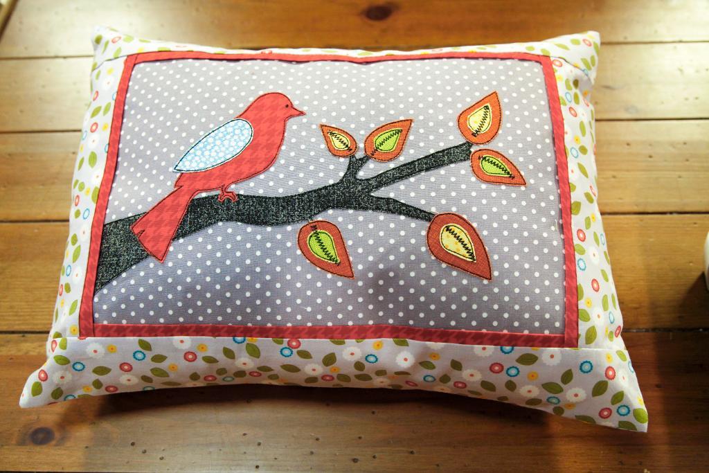 Pillow with an Embroidered Bird on It