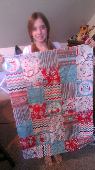 11-Year-Old Quilter Showing Her Completed Quilt