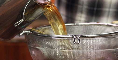 Pouring Stock Through Strainer