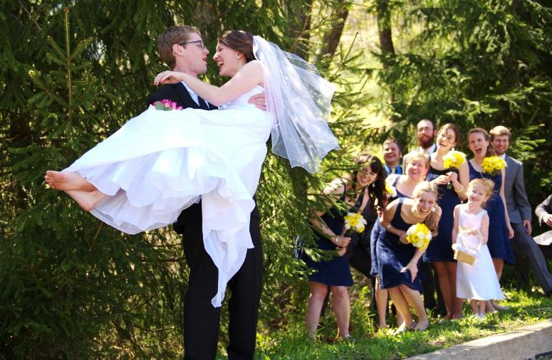 Groom Carrying Bride with Wedding Party 