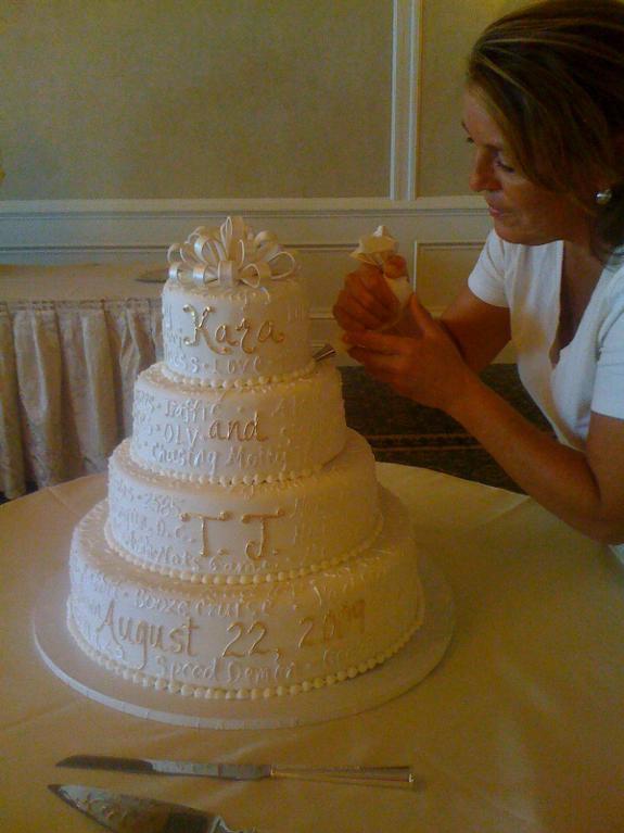 Woman Decorating a Tiered Wedding Cake