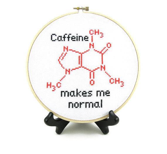 Molecule structure of caffeine in cross stitch in a hoop frame with text caffeine makes me normal