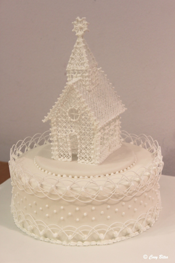 A Cake With Royal Icing Church and Stringwork