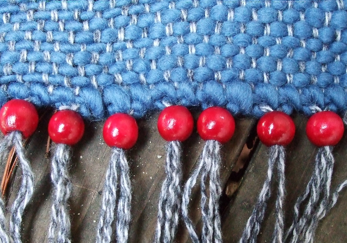 weaving with red beaded fringe