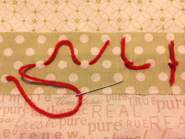 Continuous knotting in red yarn on a quilt