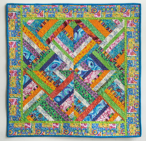 Beautiful, colorful quilt ising a focus fabric