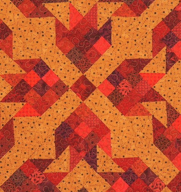 Quilt with a variety of red fabrics