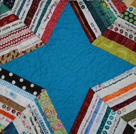 A quilt block made with selvage pieces