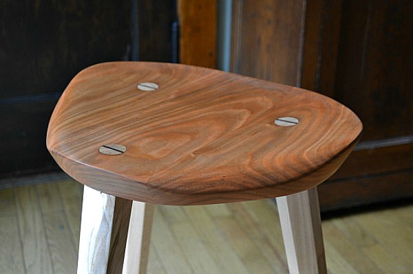 Smoothly-sanded cherry seat for three-legged stool
