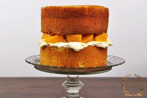 Overfilled peach and white chocolate cake by Juniper Cakery