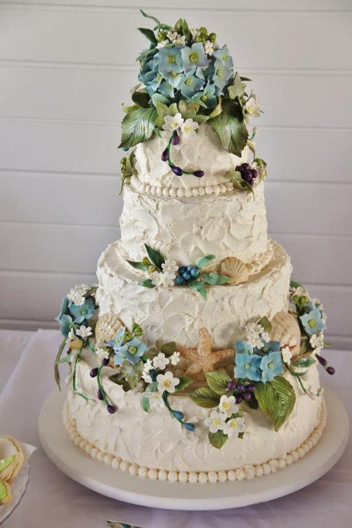 Beach wedding cake with blue flowers 