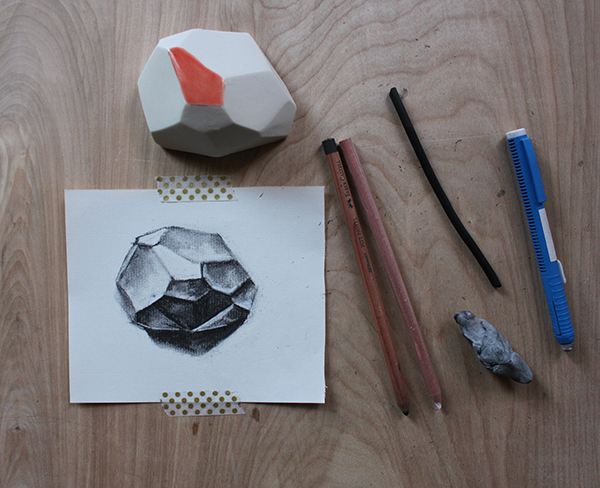 Completed charcoal drawing of a geometric shape