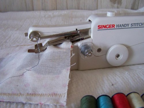 Hand held sewing machine