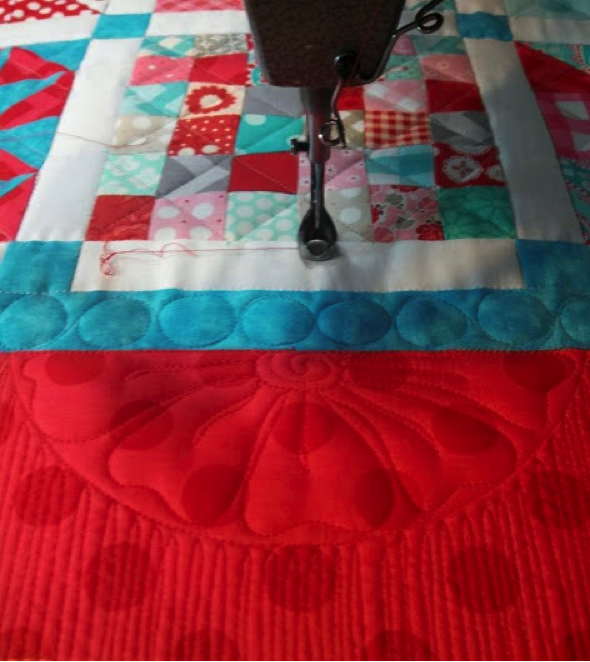 Red, white and blue patchwork quilt with crosshatching 