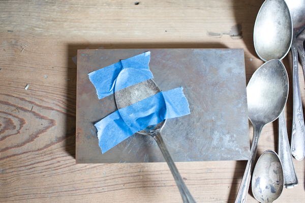 Spoon Taped Down to a Block for Hammering