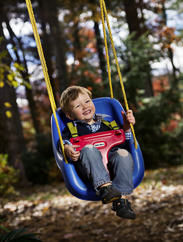 Portrait of a Little Boy on a Swing