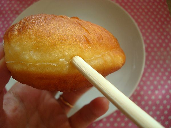 Making room for cream filling in a homemade doughnut