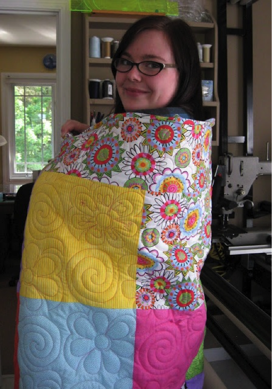 Woman wrapped in a colorful quilt 