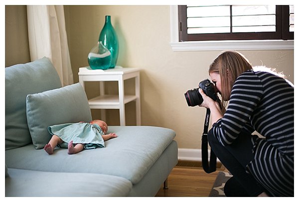 photographer taking photo of newborn