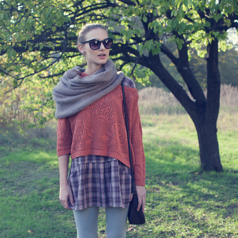 Stylish Woman in Knit Scarf, Sweater & Plaid Skirt