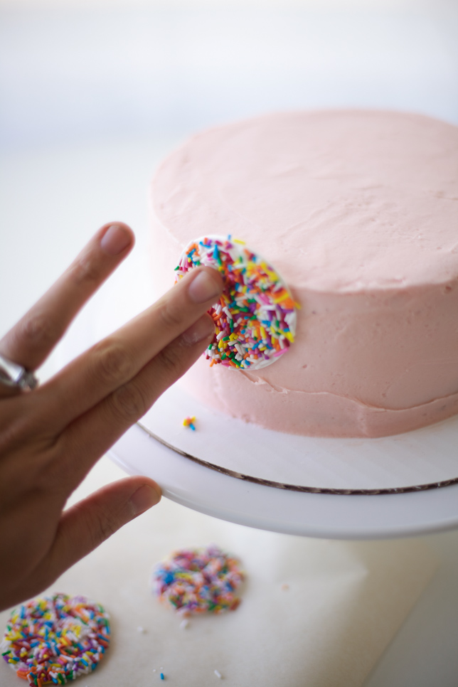 Decorating a simple layer cake with rainbow sprinkle polka dots