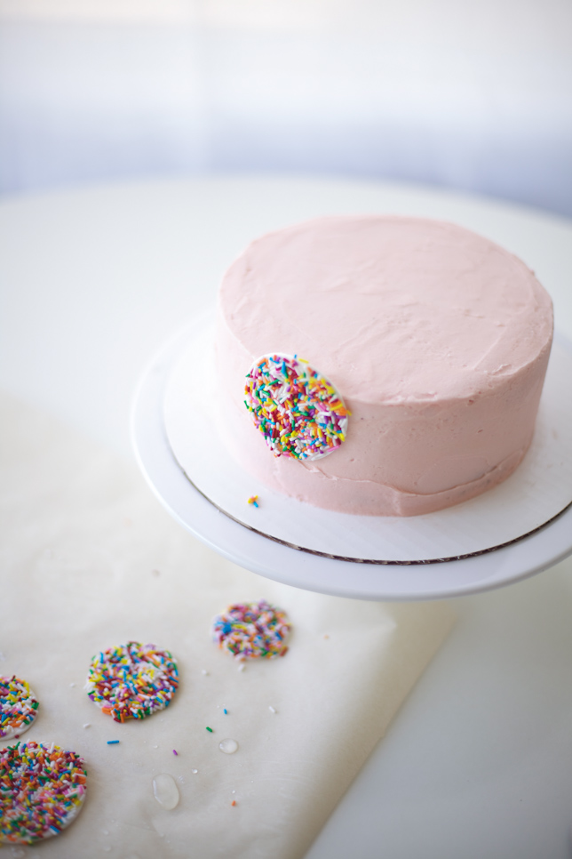 decorating a pink buttercream layer cake