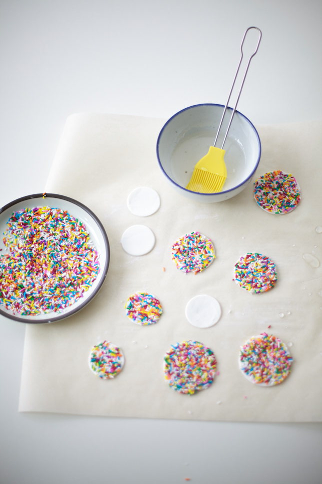 Gum paste circles covered in rainbow sprinkles