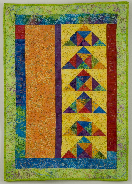 Colorful wall quilt with modern flying geese