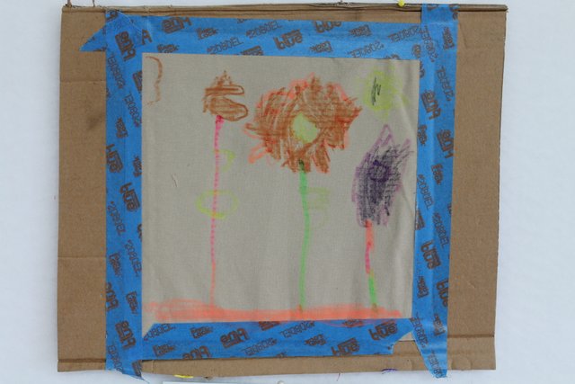 Picture drawn onto fabric with crayon.