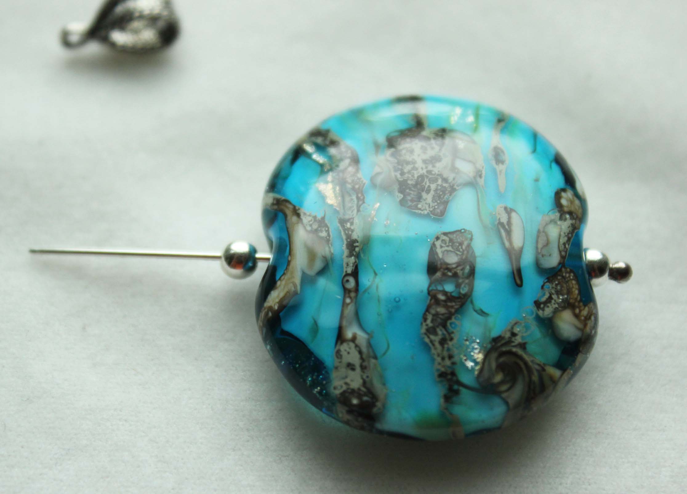 Add the lampwork bead and another silver round to the headpin