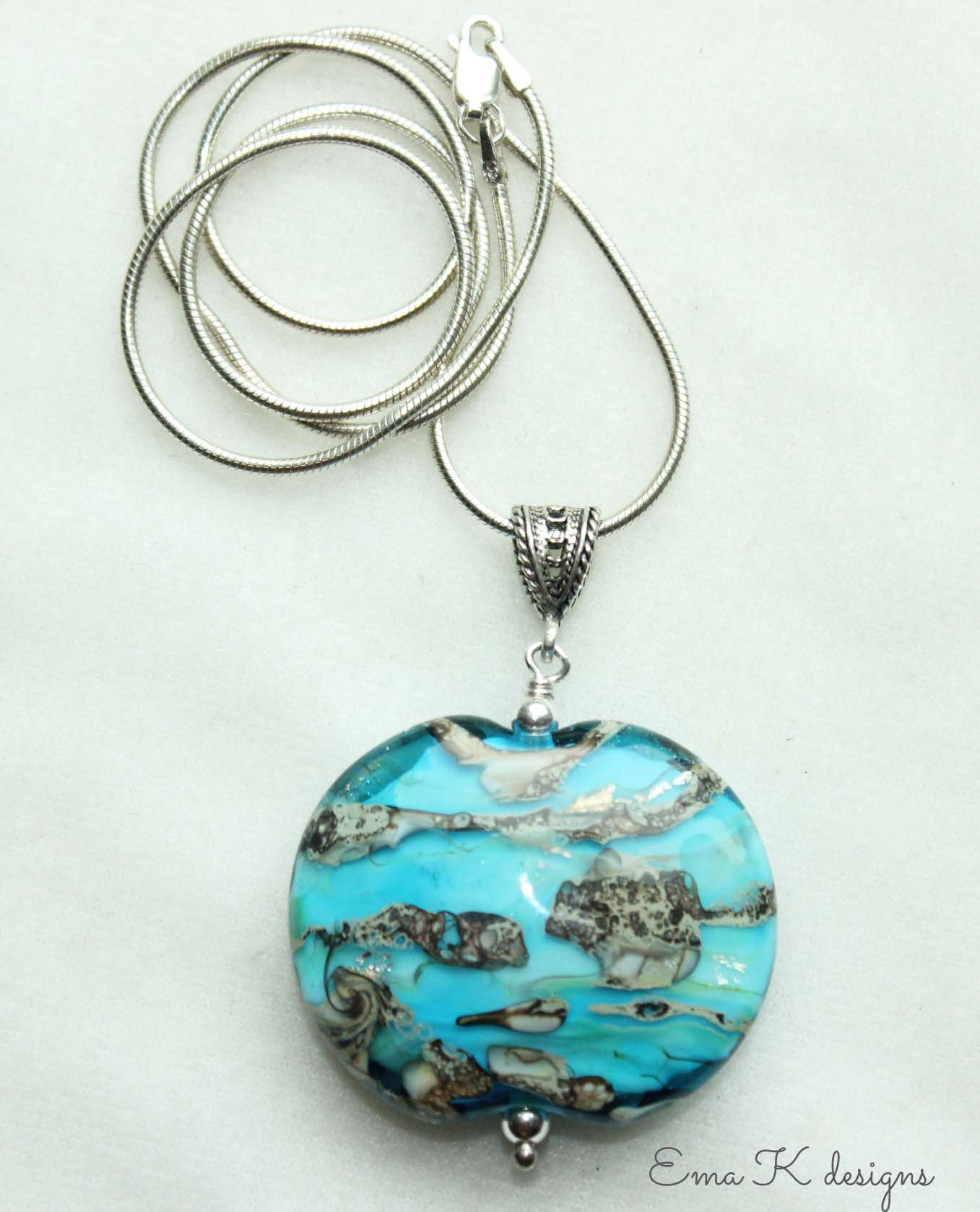 Art bead strung on a silver pendant