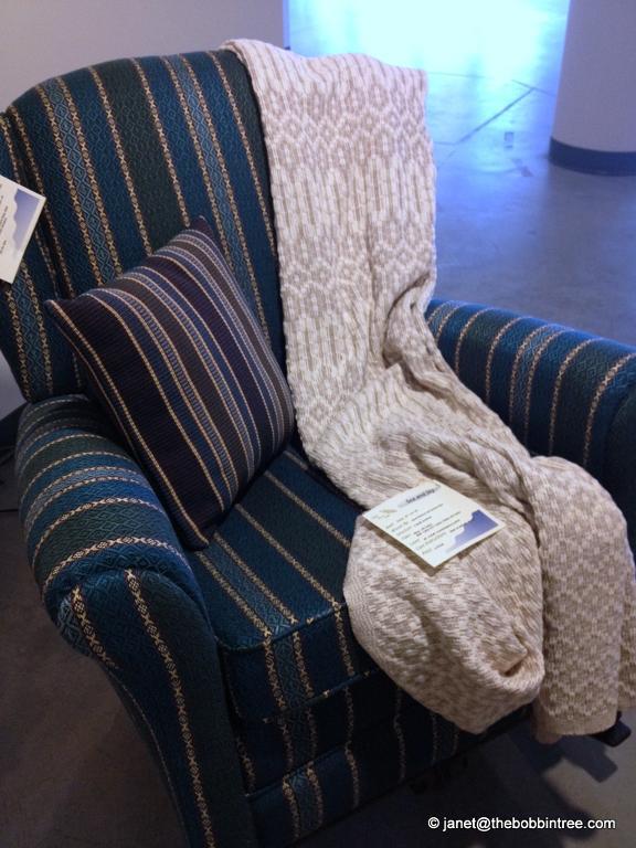 chair covered with handwoven fabric and a blanket and pillow