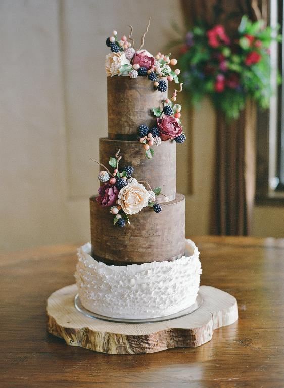 Beautiful rustic ganache wedding cake with berries and peonies