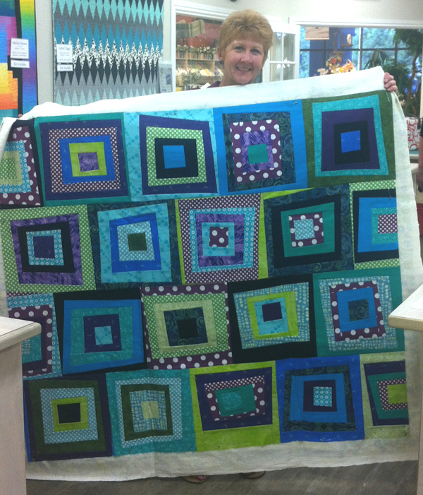 One of my students preparing to machine quilt her Modern Logs quilt