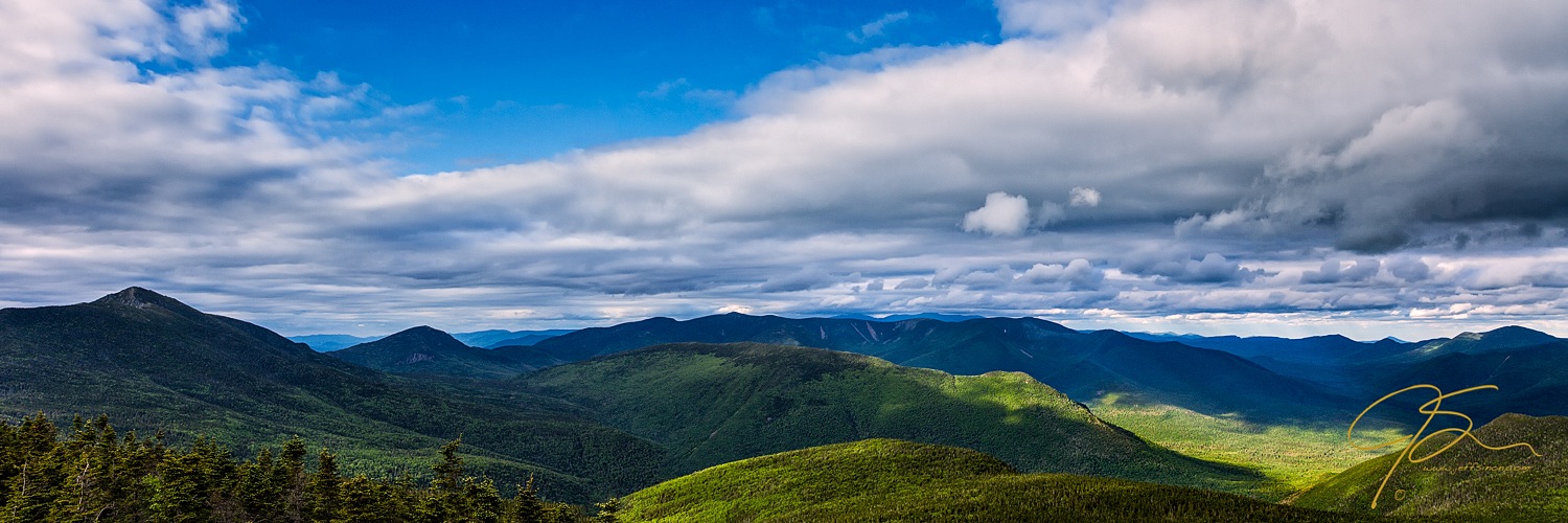 Panoramic cloud filled sky over the Pemigewasset Wilderness in the White Mountains.